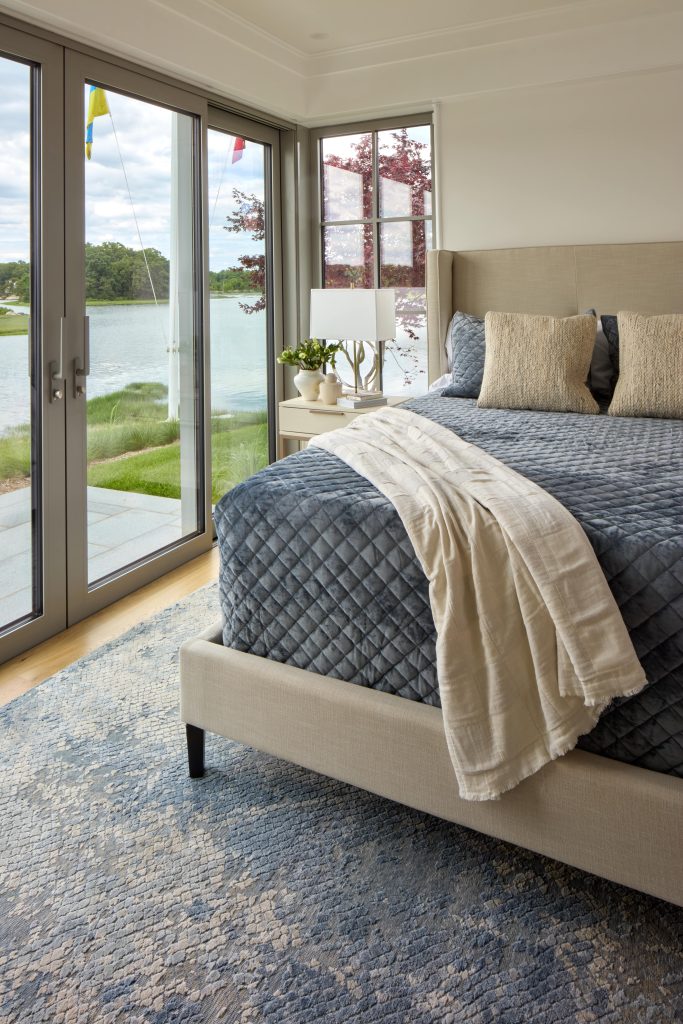 Coveledge bedroom bed and doors leading to a backyard patio